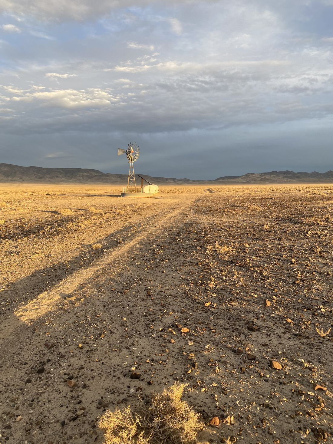 Windmill and water tank at golden hour on the Granite Springs Valley project, Nevada